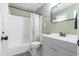 Bathroom featuring a white tub and gray vanity with a gray and white color scheme at 1316 Garden Crest Cir, Raleigh, NC 27609