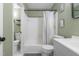 Full bathroom with a tub, toilet, and white and grey vanity with soft green walls at 1316 Garden Crest Cir, Raleigh, NC 27609