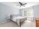 Comfortable bedroom features a ceiling fan, a large window and a metal bed frame at 1316 Garden Crest Cir, Raleigh, NC 27609