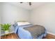 Cozy bedroom with wood floors, ceiling fan and blue bedding at 1316 Garden Crest Cir, Raleigh, NC 27609