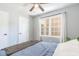 Bright bedroom features wood floors, ceiling fan, and large window at 1316 Garden Crest Cir, Raleigh, NC 27609
