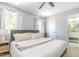 Spacious bedroom with large bed, ceiling fan, bedside tables, and attached updated bathroom at 1316 Garden Crest Cir, Raleigh, NC 27609