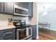 Modern kitchen features stainless steel appliances, gray cabinetry, and white subway tile backsplash at 1316 Garden Crest Cir, Raleigh, NC 27609