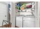 A functional laundry area features a washer, dryer, and storage shelves at 1316 Garden Crest Cir, Raleigh, NC 27609