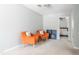 Inviting sitting area features two cozy orange chairs and soft neutral carpeting at 1316 Garden Crest Cir, Raleigh, NC 27609