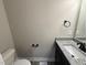 Bright bathroom featuring a modern sink with granite counters, black fixtures, and a toilet at 134 Royal Ave, Selma, NC 27576