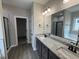 The primary bathroom has a double sink vanity, granite countertop, and shower at 134 Royal Ave, Selma, NC 27576