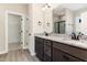 Double vanity bathroom featuring granite countertops, dark cabinetry, and a glass-enclosed shower at 134 Royal Ave, Selma, NC 27576