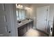 Elegant bathroom with a soaking tub, granite countertops, dual sinks, and modern lighting fixtures at 134 Royal Ave, Selma, NC 27576
