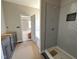 Bathroom featuring a modern shower with herringbone pattern and dark cabinets at 134 Royal Ave, Selma, NC 27576
