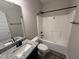 Bright bathroom with a granite vanity countertop, a large mirror, and a shower with black hardware at 134 Royal Ave, Selma, NC 27576