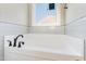 Bright bathroom featuring a large white bathtub and white subway tile backsplash at 134 Royal Ave, Selma, NC 27576
