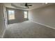 This primary bedroom offers plush carpeting, neutral walls, and a tray ceiling with fan at 134 Royal Ave, Selma, NC 27576