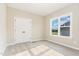 Well-lit bedroom with a double door closet and view of the front yard at 134 Royal Ave, Selma, NC 27576