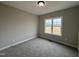 The carpeted bedroom is complete with a large window and neutral walls at 134 Royal Ave, Selma, NC 27576