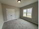 The carpeted bedroom features a large closet and natural light at 134 Royal Ave, Selma, NC 27576