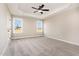 Spacious bedroom featuring tray ceilings, neutral carpet, and views of the outdoors at 134 Royal Ave, Selma, NC 27576