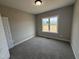 Neutral bedroom featuring soft carpet, a large window for natural light, and a fresh coat of paint at 134 Royal Ave, Selma, NC 27576