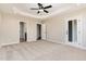 Bedroom with tray ceiling and multiple closets and doorways at 134 Royal Ave, Selma, NC 27576