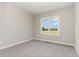 Neutral bedroom with a large window offering a clear view of the outdoors at 134 Royal Ave, Selma, NC 27576