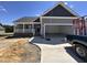 Charming single-story home featuring a covered porch, two-car garage, and fresh landscaping at 134 Royal Ave, Selma, NC 27576