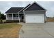 Charming single-Gathering home boasts a two-car garage, covered porch and low-maintenance landscaping at 134 Royal Ave, Selma, NC 27576