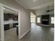 An open floor plan features luxury vinyl plank flooring, and a stunning fireplace with stone surround at 134 Royal Ave, Selma, NC 27576