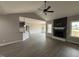 An open floor plan boasts luxury vinyl plank flooring and a fireplace with stone surround at 134 Royal Ave, Selma, NC 27576