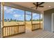 Spacious covered porch with wood floors and ceiling fan, perfect for outdoor relaxation at 134 Royal Ave, Selma, NC 27576