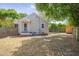 View of the house from the backyard, showcasing the fenced yard and outdoor seating area at 1429 Hudson Ave, Durham, NC 27705