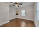Bright bedroom with hardwood flooring, a ceiling fan, and a window allowing natural light at 1429 Hudson Ave, Durham, NC 27705