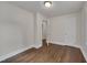 Bedroom with hardwood floors, neutral walls, and door to another room or closet at 1429 Hudson Ave, Durham, NC 27705