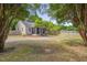 Home showcasing a large lot, mature trees, and a screened in front porch at 1429 Hudson Ave, Durham, NC 27705