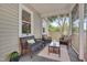 Comfortable seating area on a screened-in porch, perfect for relaxing and enjoying the outdoors at 1429 Hudson Ave, Durham, NC 27705