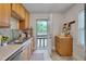 Well-lit kitchen features stainless steel appliances, neutral countertop and access to the backyard at 1429 Hudson Ave, Durham, NC 27705