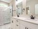 Modern bathroom featuring double vanity, framed mirror, and marble tiled shower with glass door at 1481 Carolina Dr, Sanford, NC 27332