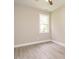 Cozy bedroom with hardwood floors, neutral paint, and a window overlooking a private yard at 1481 Carolina Dr, Sanford, NC 27332