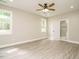 Spacious bedroom with light-colored wood flooring features a ceiling fan and ensuite bathroom at 1481 Carolina Dr, Sanford, NC 27332