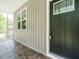Close-up of a stylish front door with elegant hardware and a patterned porch floor at 1481 Carolina Dr, Sanford, NC 27332