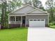 Charming single-story home featuring a covered porch, two-car garage, and a well-manicured lawn at 1481 Carolina Dr, Sanford, NC 27332