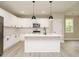 Modern kitchen featuring white cabinets, stainless appliances, and pendant lighting over the center island at 1481 Carolina Dr, Sanford, NC 27332