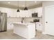Well-lit kitchen features white cabinets, stainless steel appliances, a subway tile backsplash, and a center island at 1481 Carolina Dr, Sanford, NC 27332