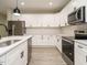 Stylish kitchen featuring white cabinets, stainless steel appliances, and a modern backsplash at 1481 Carolina Dr, Sanford, NC 27332