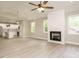 Bright living room with light wood-look floors, fireplace and a view into the modern kitchen at 1481 Carolina Dr, Sanford, NC 27332