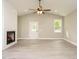 Open-concept living room with a fireplace, vaulted ceilings, and light wood-look flooring at 1481 Carolina Dr, Sanford, NC 27332