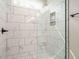 A luxurious shower with marble tiling, a rainfall showerhead, and built-in storage niche at 1481 Carolina Dr, Sanford, NC 27332