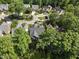 Aerial view of homes nestled among lush green trees in a suburban neighborhood at 156 Yorkchester Way, Raleigh, NC 27615
