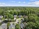 Aerial view featuring homes with lush green trees in a suburban neighborhood at 156 Yorkchester Way, Raleigh, NC 27615