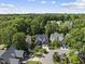 Aerial view featuring homes with lush green trees in a suburban neighborhood on a clear day at 156 Yorkchester Way, Raleigh, NC 27615