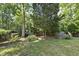 Lush backyard with mature trees, offering a serene and private outdoor space at 156 Yorkchester Way, Raleigh, NC 27615